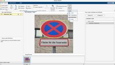 Monument of robed woman, standing, holding a crown in one hand and a partly sheathed sword in another